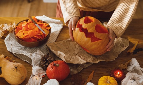 Woman holding a carved pumpkin