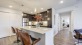 a kitchen with an island table and chairs