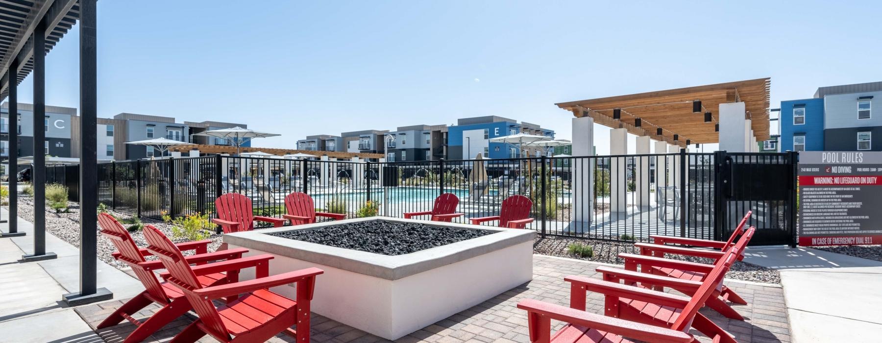 a group of red chairs on a brick patio