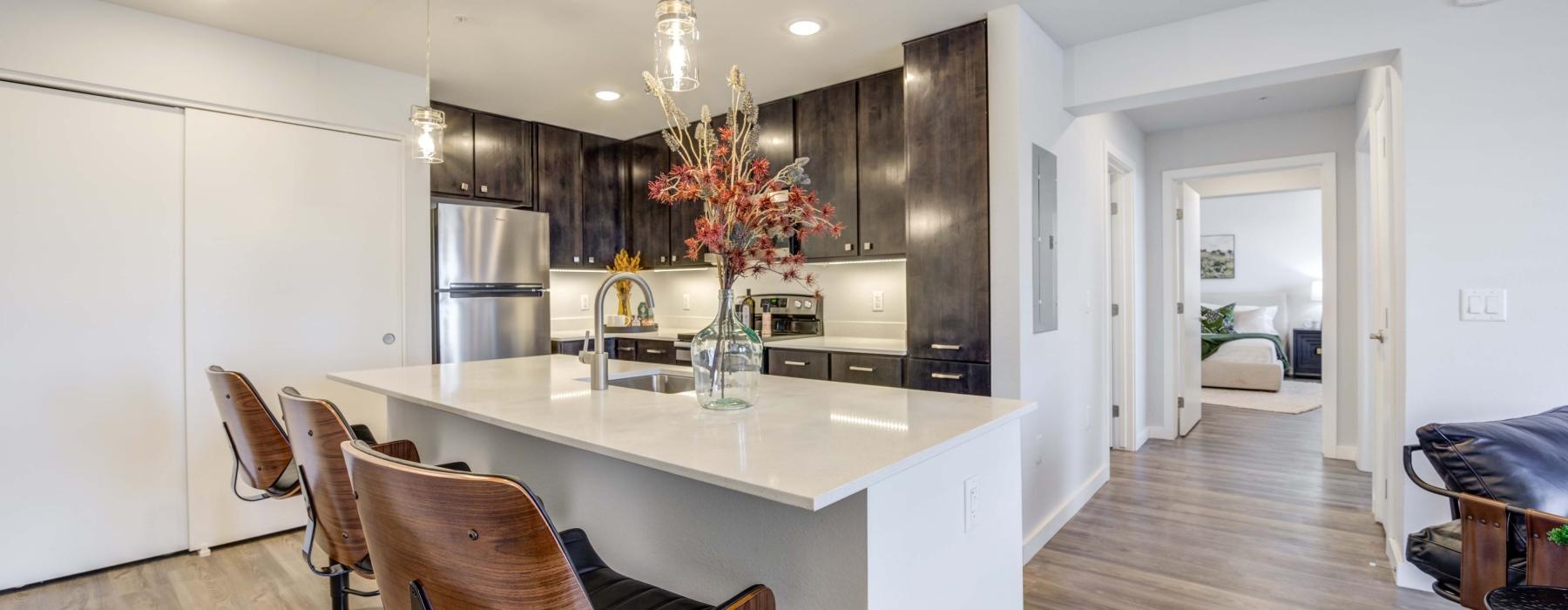 a kitchen with an island table and chairs