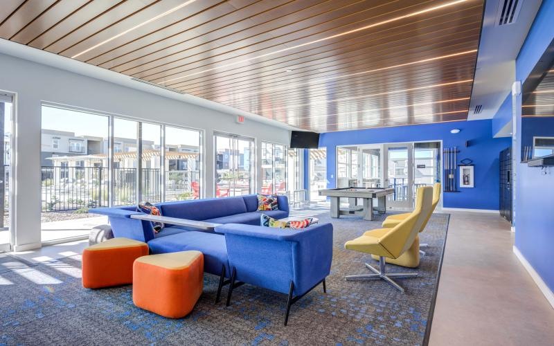 a room with blue couches and a table